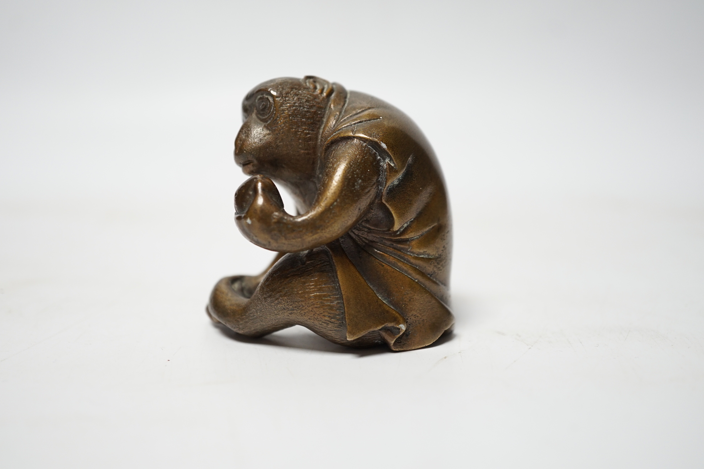 A Japanese bronze model of a monkey, 19th century, 5.5cm high